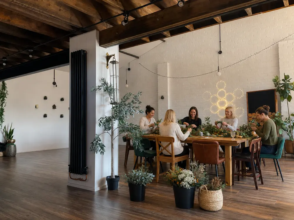 A group creating flower arrangements at The Space